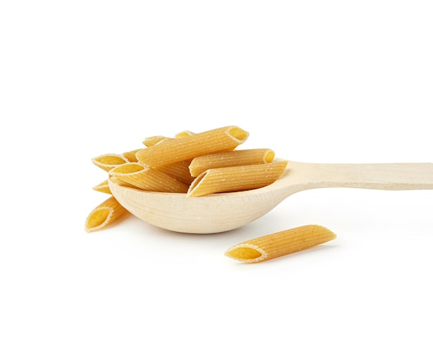 Raw pasta in wooden spoon on white background