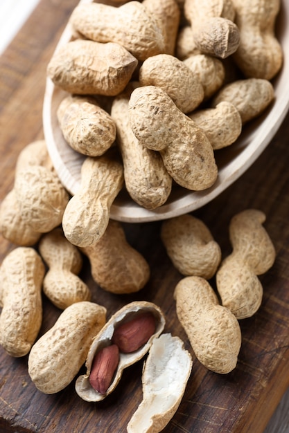 Raw peanuts seed on wooden board