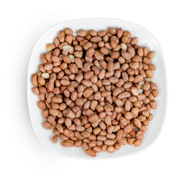 raw peanuts with dish isolated on white background include clipping path