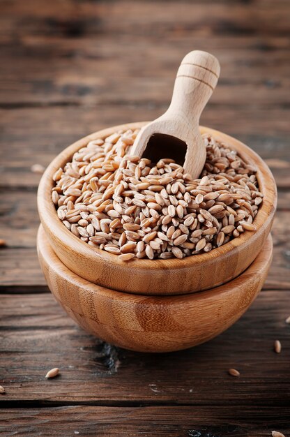 Raw pearl barley on the wooden table