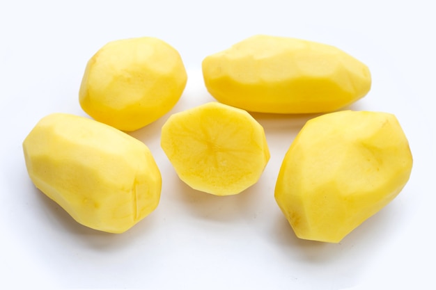 Raw peeled potatoes on white background