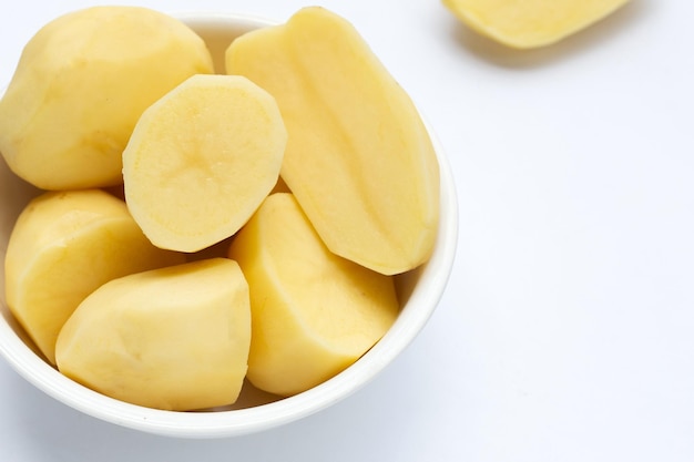 Raw peeled potatoes on white background