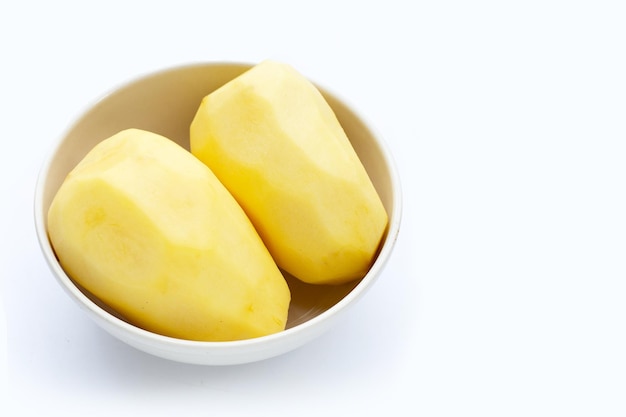 Raw peeled potatoes on white background