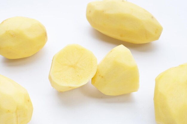 Raw peeled potatoes on white background