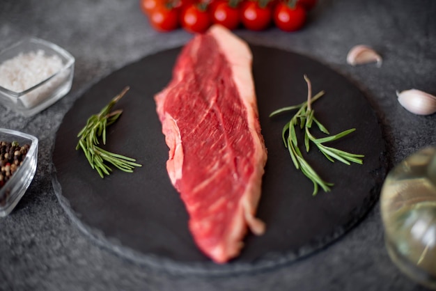 raw Picanha steak on stone background with spices