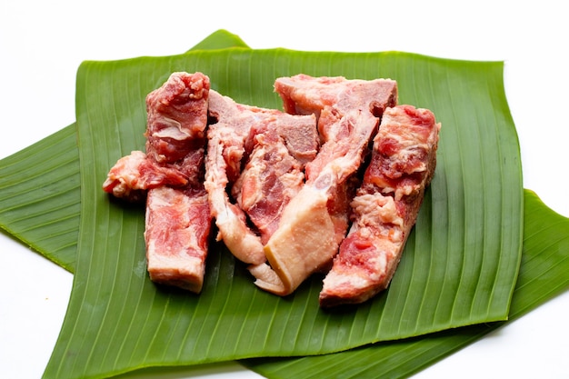 Raw pork bone isolated on banana leaf