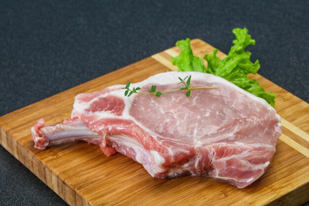 Raw pork bone steak over wooden