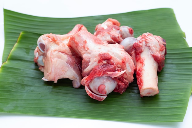 Raw pork bones on banana leaves