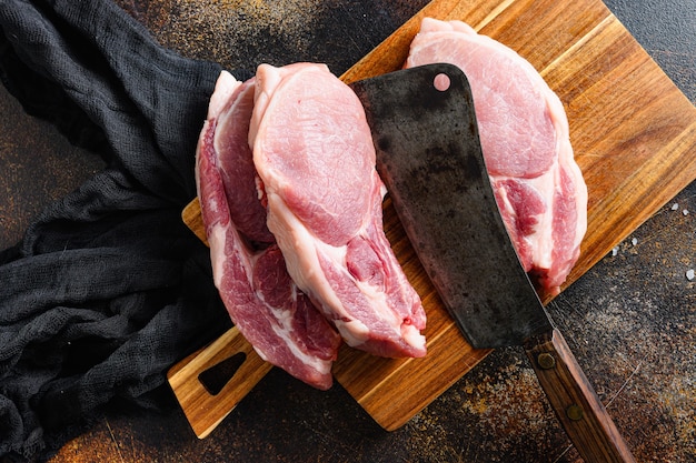 Raw pork chop on cutting board