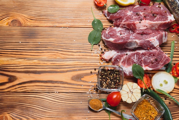 Raw pork chop steak prepare in kitchen with vegetable and spices