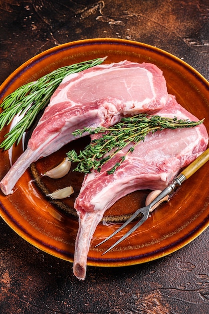 Raw pork chops meat steaks with pepper and salt