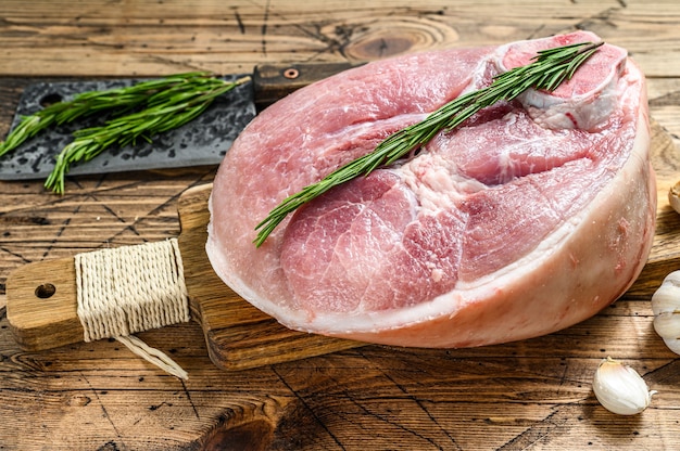 Raw pork ham cut. Leg meat. Wooden surface. Top view.