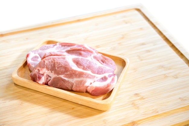 Raw Pork is prepared for Cook It is on wood plate in studio light with Chef hand background Clipping Paths