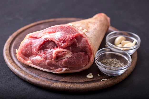 Raw pork knuckle with  garlic and spices