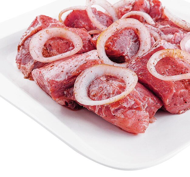 Raw pork meat with onions and spices for cooking kebabs