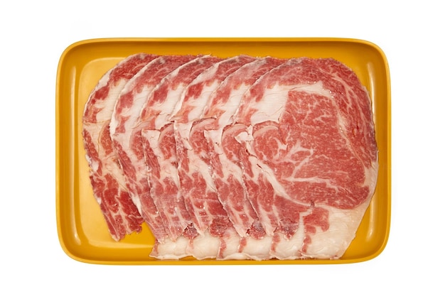 Raw pork neck sliced on plate isolated on white background,\
shabu, hot pot ingredients.