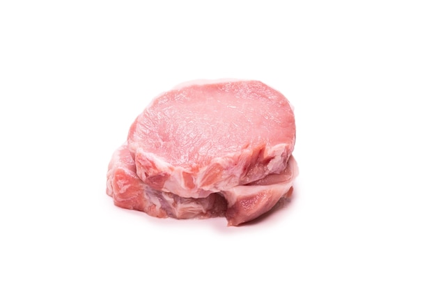 Raw pork pieces isolated on a white background. Top view.