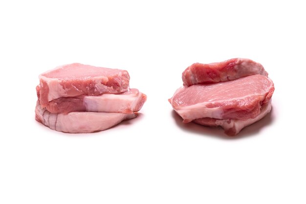 Raw pork pieces isolated on a white background. Top view.