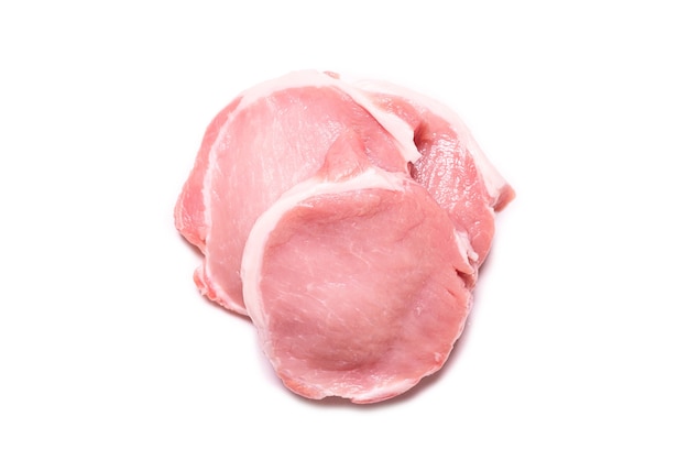 Raw pork pieces isolated on a white surface. Top view.