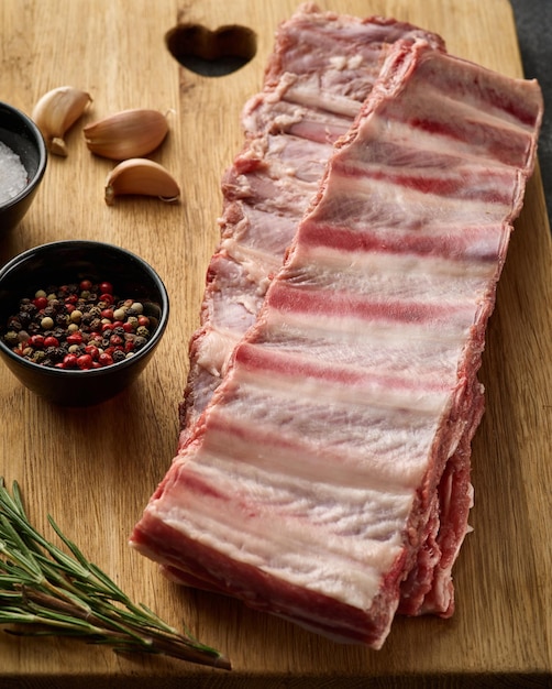 Raw pork ribs with spices salt pepper and rosemary fresh pork\
pig ribs