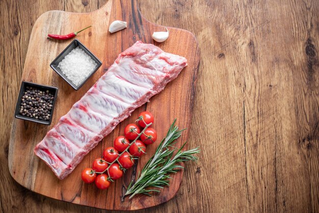 raw pork ribs on wooden background