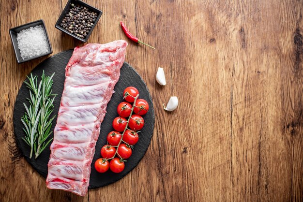 raw pork ribs on wooden background