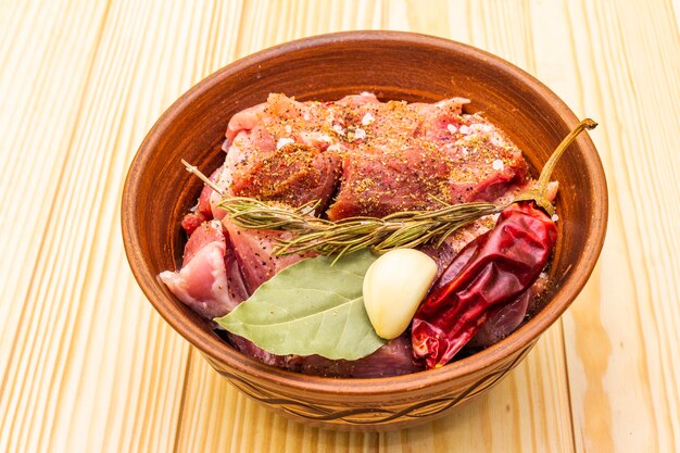 Raw pork shoulder with spices and dry herbs