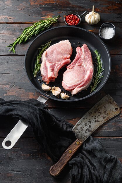 Raw pork steak on the bone in frying grill pan