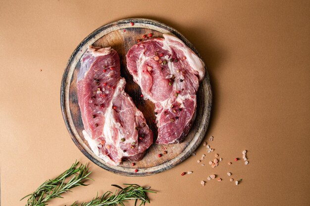 Raw pork steak on a dark background close-up