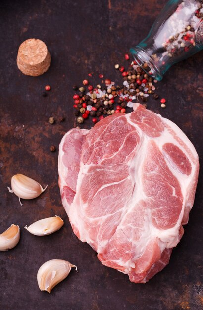 Raw pork steak neck on a dark background