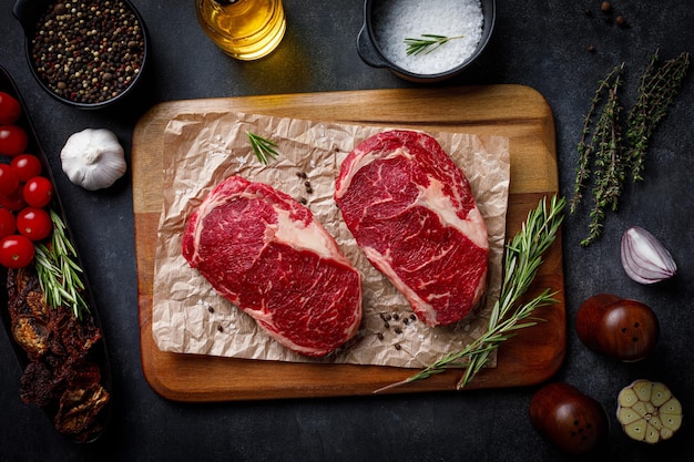 Raw pork steak pieces with spices and herbs