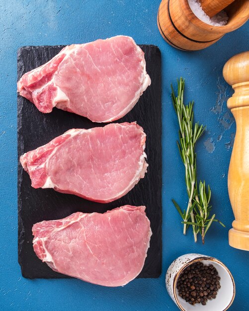 Raw pork steaks with spices