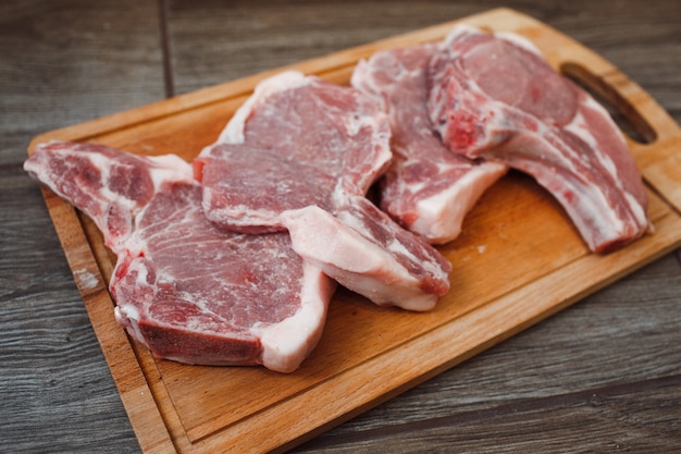 Raw pork on a wooden tray