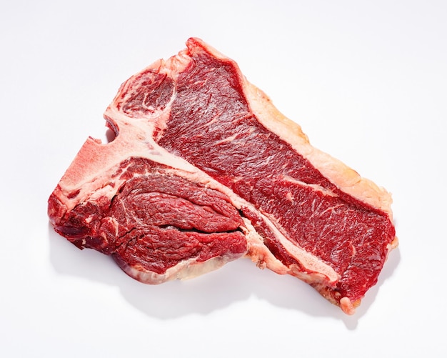 Raw porterhouse beef steak on a white background