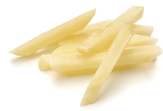 Raw Potato sliced strips prepared for French fries isolated on white background