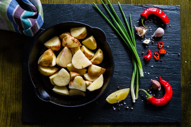 Raw potato slices with herbs, spices