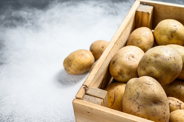 Raw Potatoes in an old wooden box