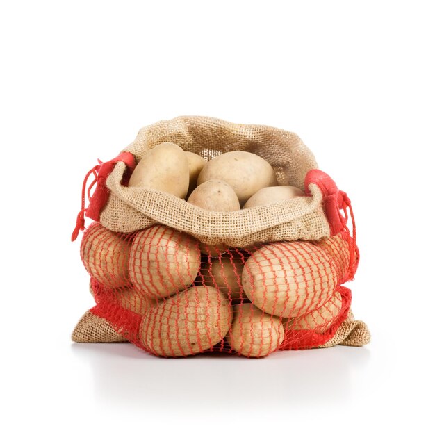 Raw potatoes in red jute sack on white background