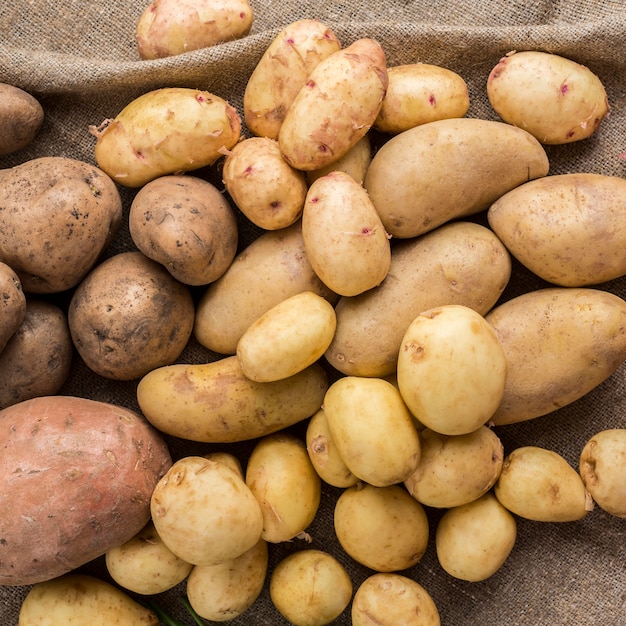 Raw potatoes on table