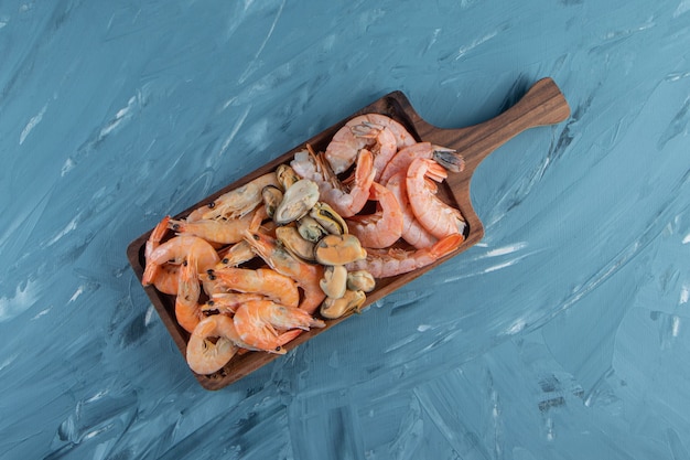 Raw prawns on a board , on the marble surface.