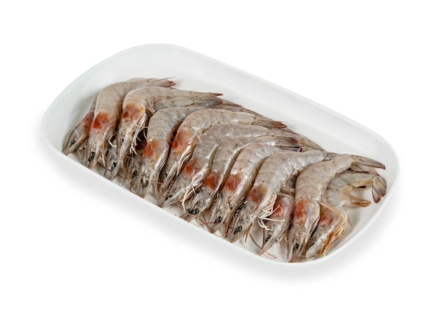 Raw prawns on plate over white background