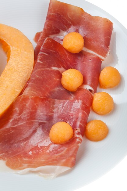 Raw prosciutto with melon