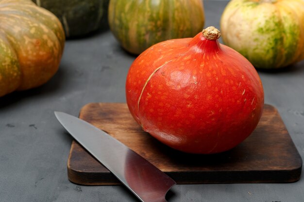 Raw pumpkin on a wooden board