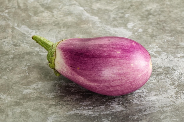 Raw purple ripe eggplant for cooking over background