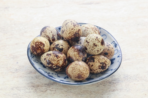 Raw quail eggs heap in the bowl