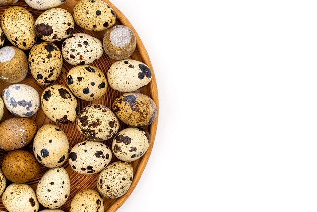 Raw quail eggs on a white background on a plate top view healthy eating concept