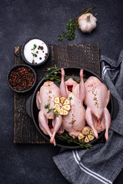 Raw quail meat with spices garlic and herbs