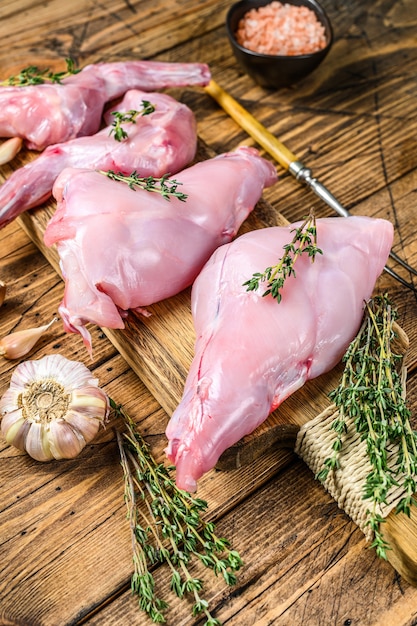 Raw rabbit legs on a cutting board