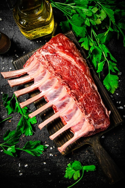 Raw rack of lamb with parsley and oil