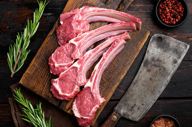 Raw Rack and rib chops of lamb, mutton set, on old dark  wooden table background, top view flat lay